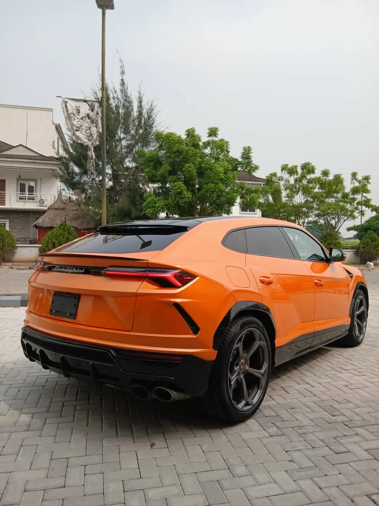 Orange Lamborghini Urus rear three-quarter view, Lagos hire