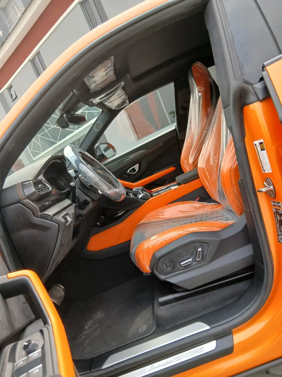 Lamborghini Urus orange front seats and cabin, Lagos rental
